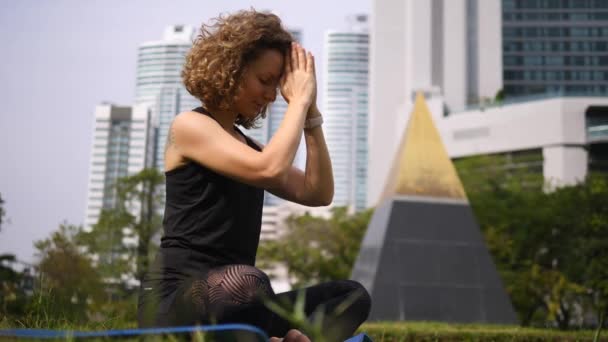 Stile di vita sano della donna grata che fa yoga nel parco della città — Video Stock