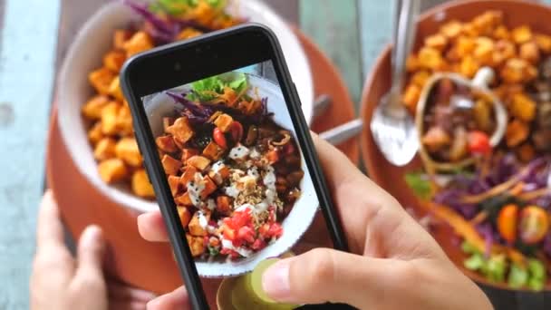 Крупный план рук, фотографирующих веганскую еду с помощью мобильного телефона — стоковое видео