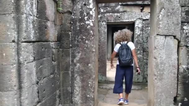 Genç bayan turist Antik Angkor Wat Tapınağını geziyor. — Stok video