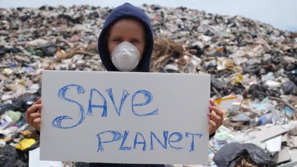 Woman with Save Planet Board Against Garbage Dump — Stock Video