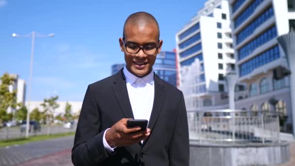 Счастливый бизнесмен с мобильным телефоном на улице — стоковое видео