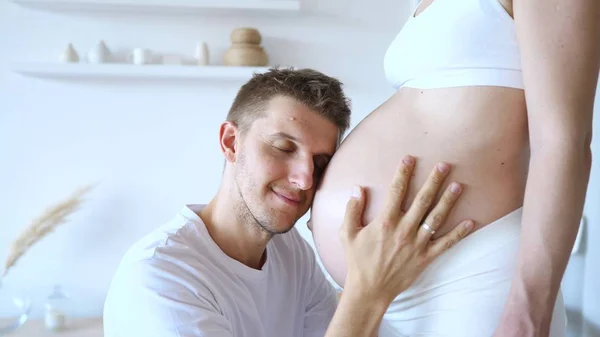 Happy Man Kissing Belly Of His Pregnant Wife. — Stock Photo, Image