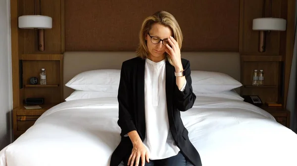 Stressed Business Woman Sitting On Bed Feel Tired