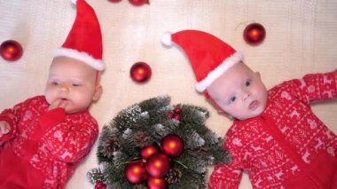 Christmas Celebration Concept. Funny Baby Twins In Christmas Hats.