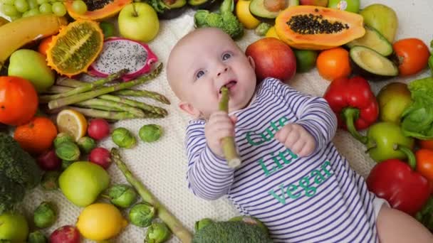 Engraçado bebê tentando espargos e franja. Comida suplementar e novo conceito de sabor . — Vídeo de Stock