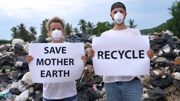 Environmental Activists Standing On Waste Landfill Fighting Against Pollution
