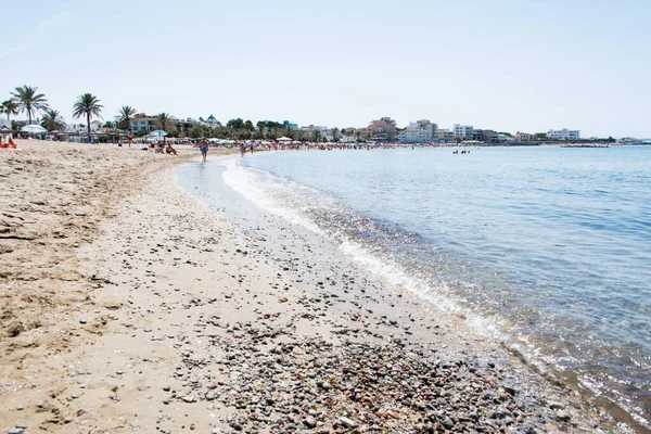 Ciudad Jardin, Mayorka 'da insanlarla dolu bir sahil ve deniz manzarası.