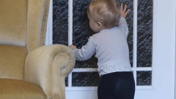 Funny Standing Cute Infant Opens Door Crawls Away Smooth Zoom — Stock Video