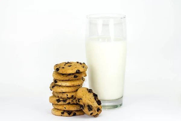 A stack of chocolate chip cookies and glass of milk on a white background. — Stock Photo, Image