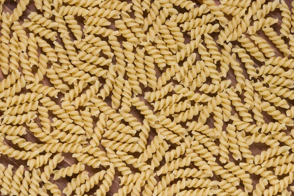 Raw macaroni on a wooden background. Mix pasta. Close up — Stock Photo, Image