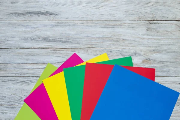 Color paper on wooden background bottom — Stock Photo, Image