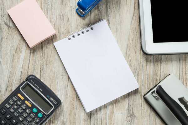 Office tools organized on white wooden background