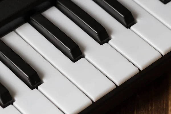 Piano keyboard close-up on wooden background — Stock Photo, Image