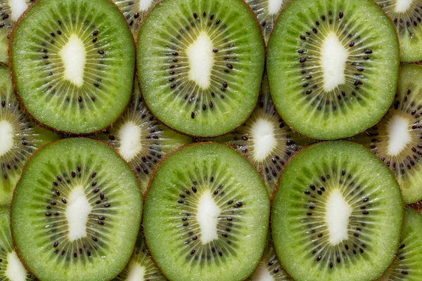 Pedaços fatiados de textura de fundo kiwi — Fotografia de Stock
