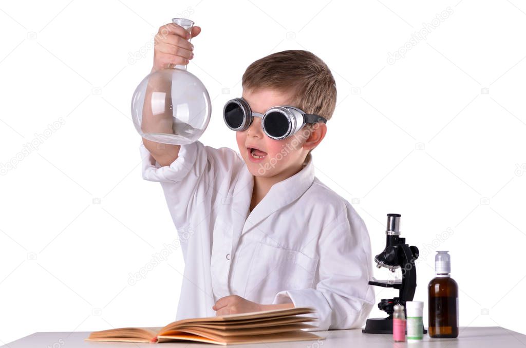 Scientist boy in black glasses holds an empty flask in his hand