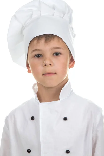Confiante bonito menino no Chef uniforme no branco fundo — Fotografia de Stock