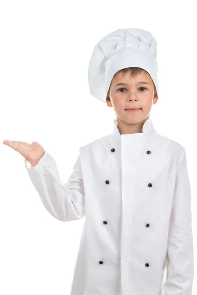 Bonito menino no chef uniforme no luz fundo — Fotografia de Stock