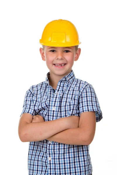 Handsome boy in blue checkered shirt and yellow building helmet, smiling on white background Stock Picture