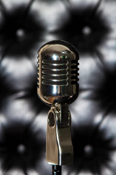 Vintage microphone on the luxury, black leather background — Stock Photo, Image