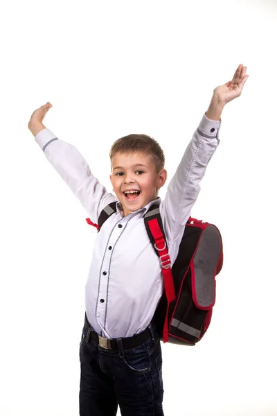 Alegre niño de la escuela feliz con las manos arriba, sobre el fondo blanco. Fin del año escolar . — Foto de Stock