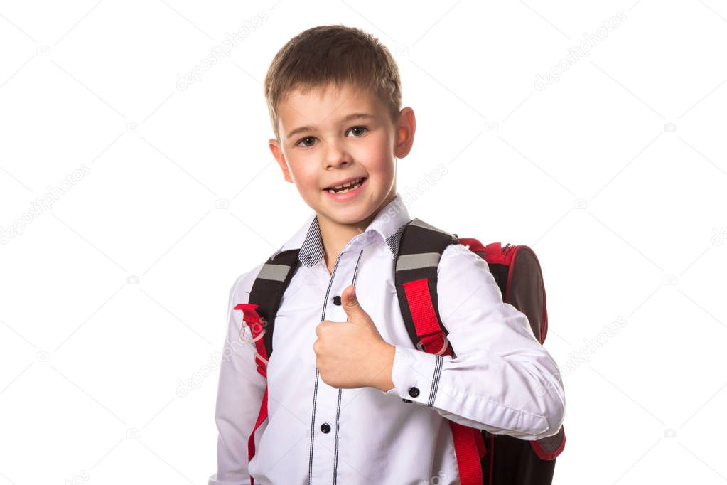 Cheerful school boy portrait with backpack, with thumb up, love going to school on white background