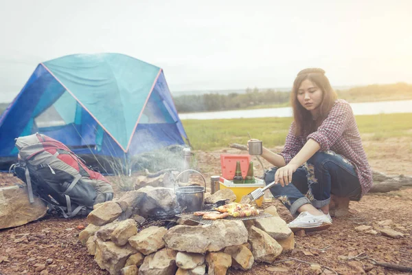 Sip coffee in a glass, grill and barbecue. Romantic atmosphere. Relaxing time camping on a mountain. Activity in holiday concept. Selective Focus bonfire.
