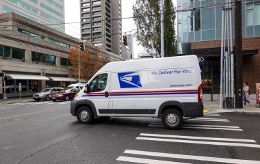 Seattle, WA/USA-6/15/19:  A United States Postal Service, USPS,  Truck making deliveries in an urban area. clipart