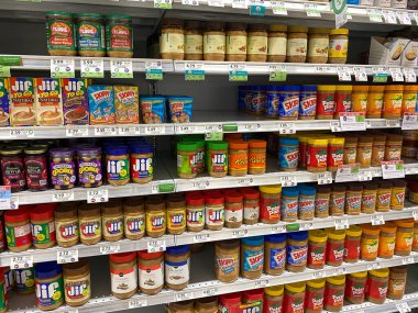 Orlando, FL/USA-5/4/20:  A display of jars of various Peanut Butter brands at a Publix grocery store waiting for customers to purchase. clipart