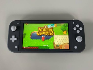 Orlando, FL / USA -5 / 27 / 20: A Nintendo Switch Lite with the game Crossing New Horizons on on it.