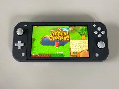 Orlando, FL / USA -5 / 27 / 20: A Nintendo Switch Lite with the game Crossing New Horizons on on it.