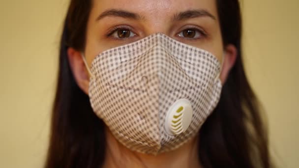 White woman removes a protective mask in front of the camera — Stock Video