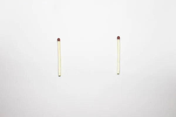 Two whole matches on a white background