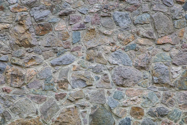 gray wall built of large stones and concrete