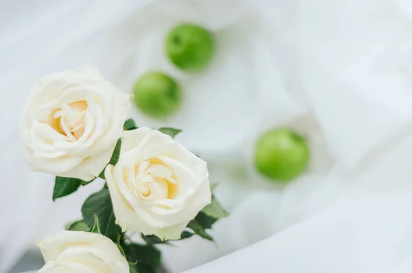 light photo of white roses. green apples on the background. subject photo of the house