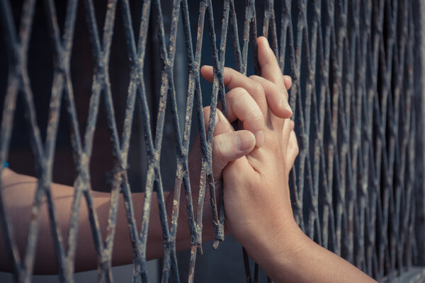Hands of the man and woman on a steel lattice
