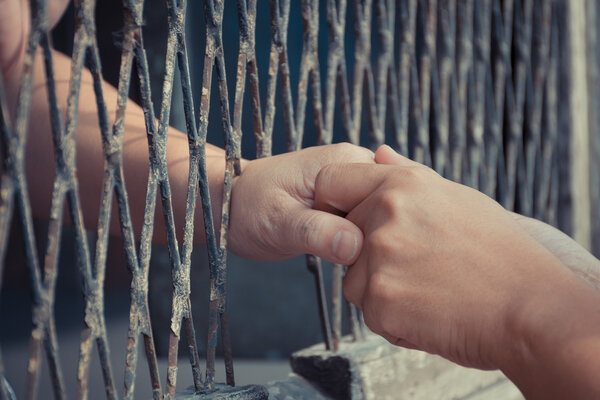 Hands of the man and woman on a steel lattice