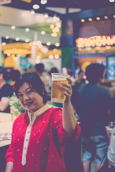 Asia woman holding a beer