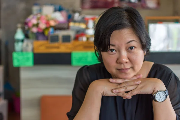 Asia mujeres en vestido negro thao barbilla en la cafetería — Foto de Stock