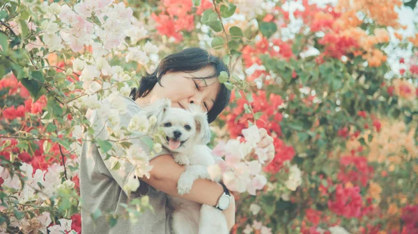 Asia women and dog happy smile hugging