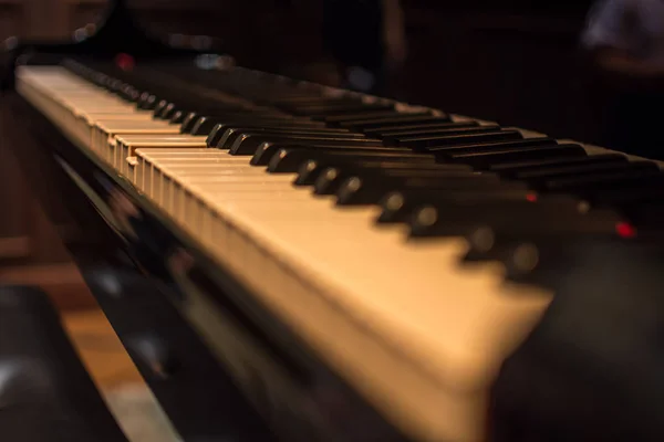 Piano keys on black classical grand piano — Stock Photo, Image