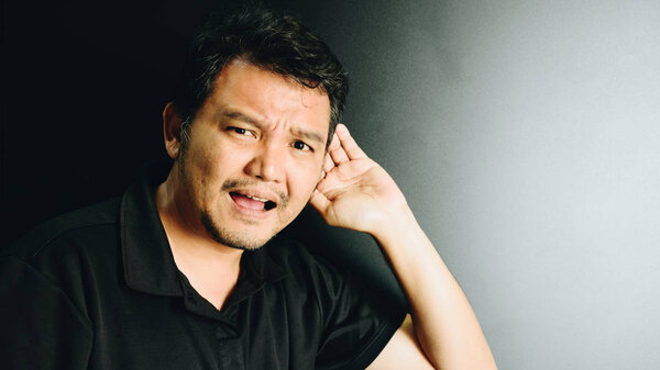 Asia man deaf hearing for listening in dark style