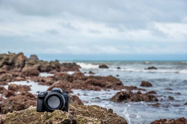 Camera on a beach it wet from sea wave — Stock Photo, Image