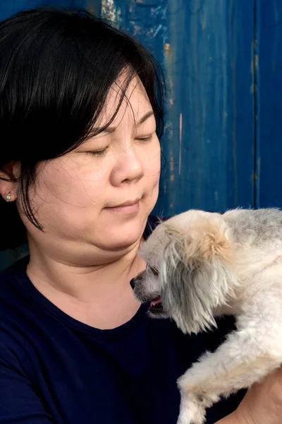 Asia women and dog happy hugging with container