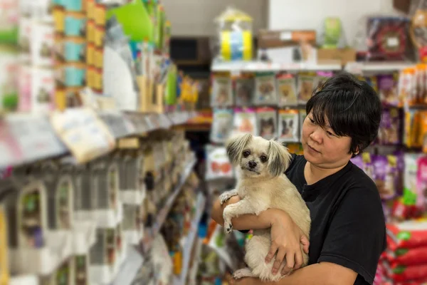 Women and her dog shop at pet shop
