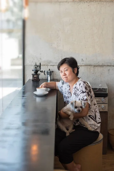 Asian women and dog in coffee shop cafe