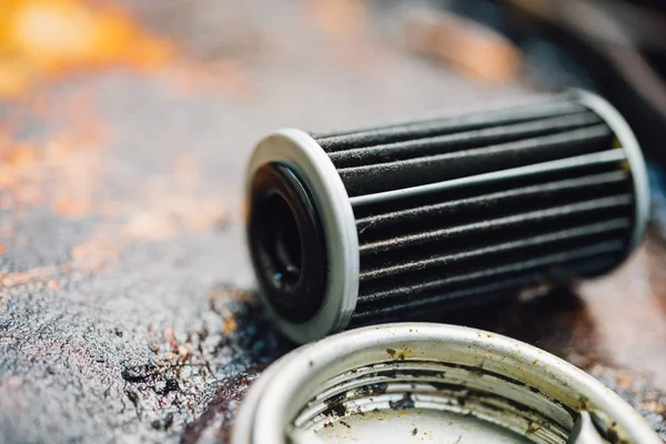 Old lubricant engine oil filter at car garage