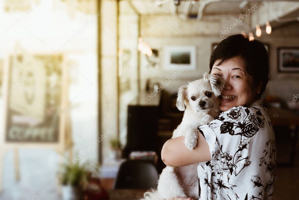 Asian woman and dog in coffee shop cafe