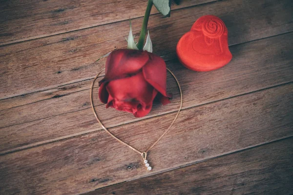 Red rose flower on wooden floor in Valentine's Day