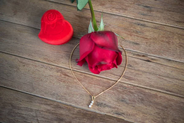 Red rose flower on wooden floor in Valentine\'s Day