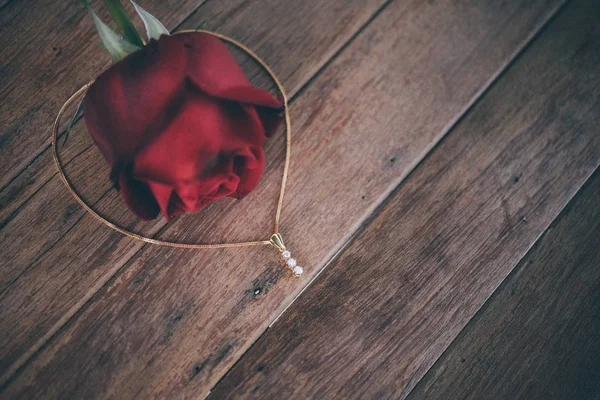 Red rose flower on wooden floor in Valentine\'s Day
